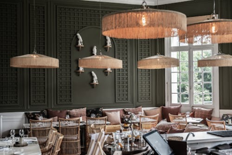 restaurant-dining-interior-seating Restaurant dining room with tables, chairs, and hanging light fixtures